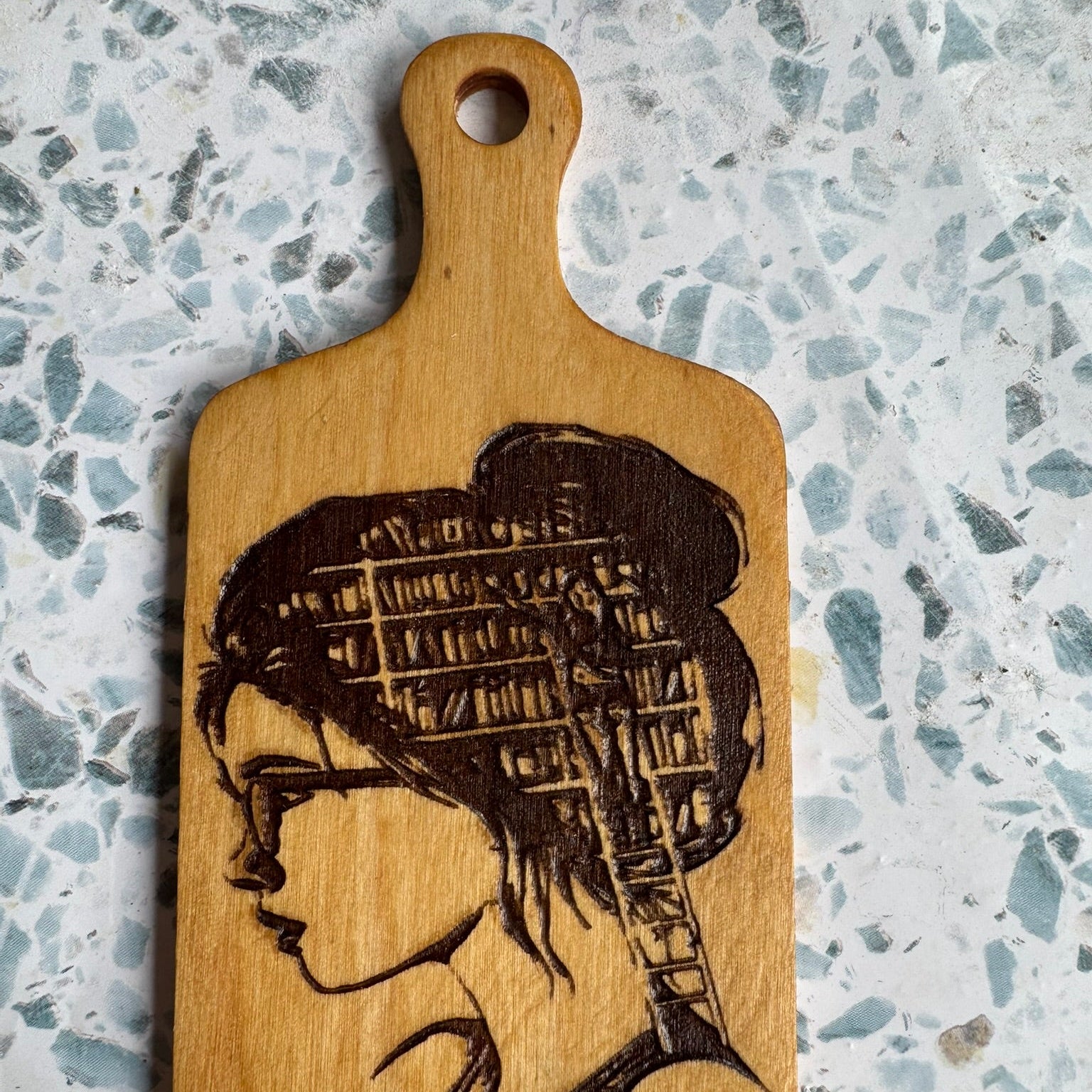 6-inch hand-burned wooden paddle featuring a woman with a bookshelf in her hair — a perfect handmade gift for book lovers, teachers, or literary decor fans.