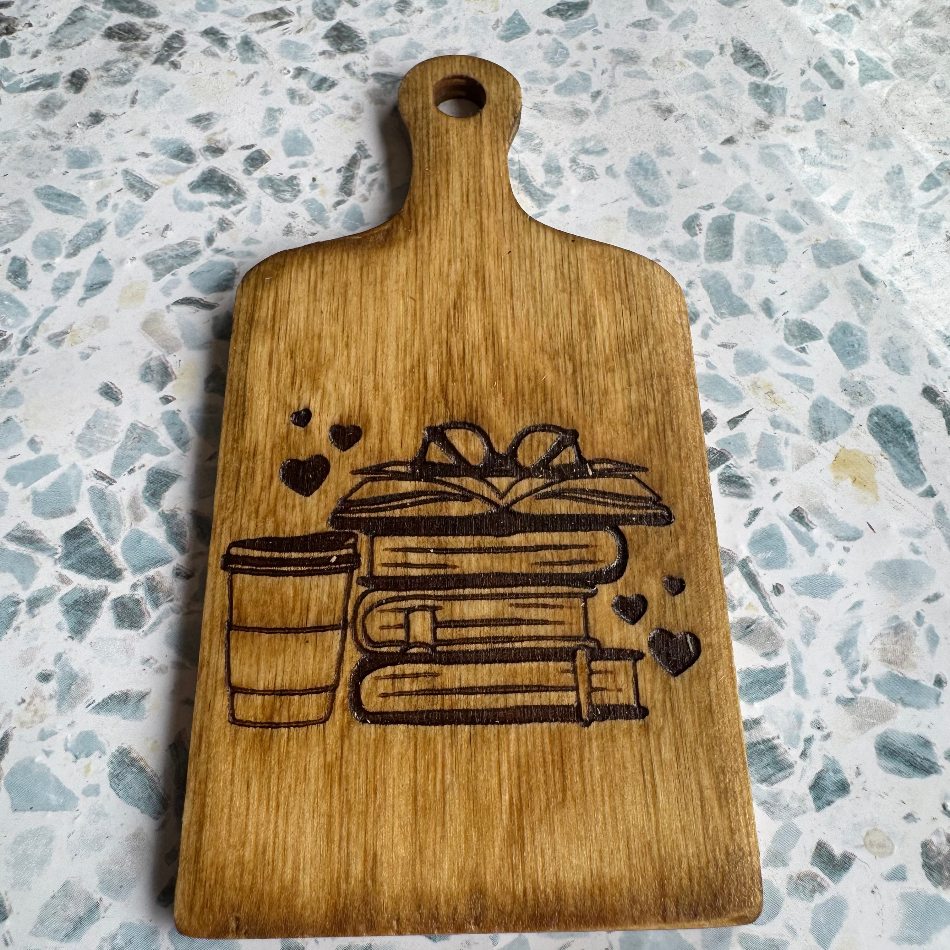 6-inch board with an engraved design on a speckled countertop